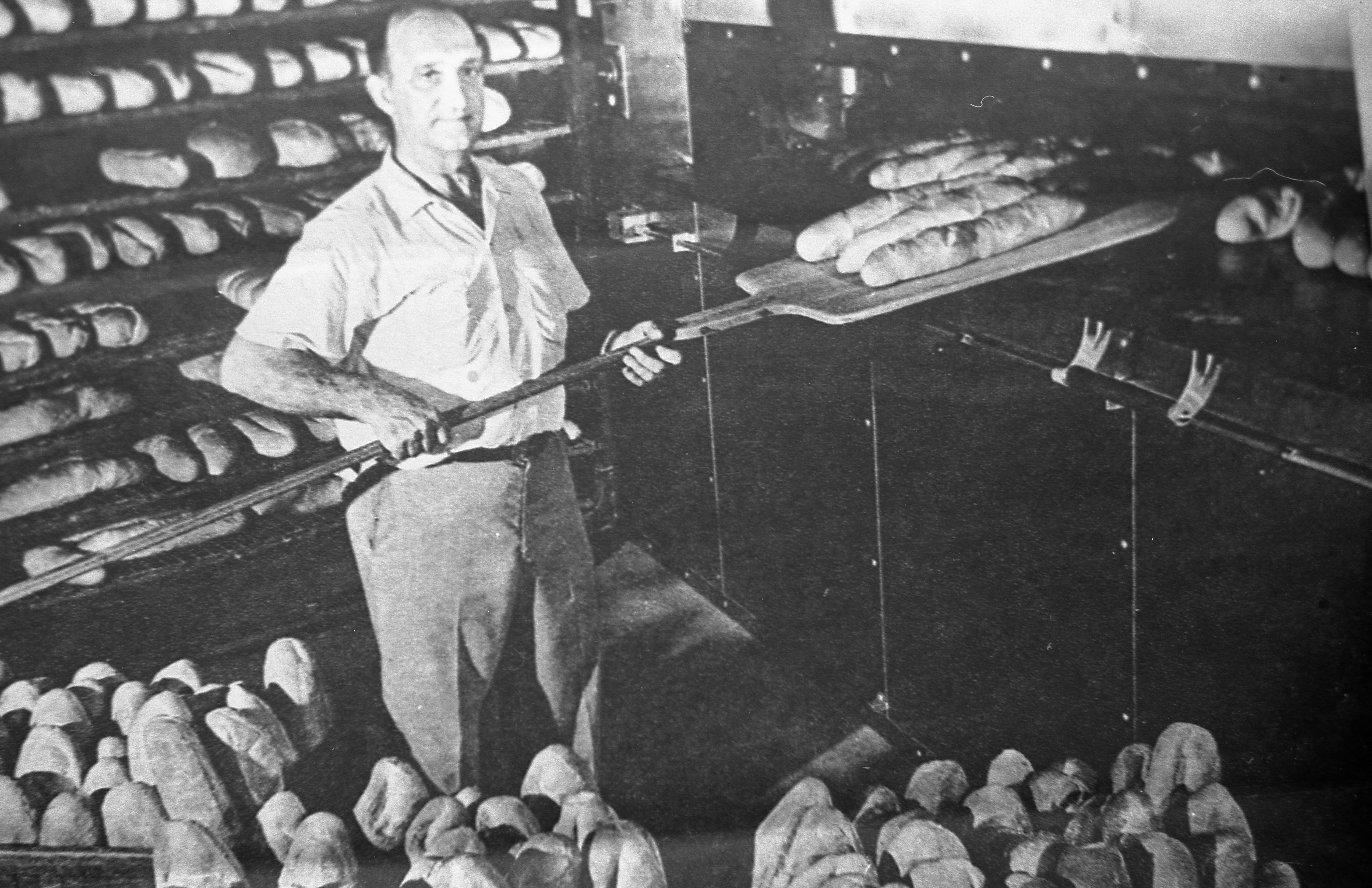 Historic Maranto Bakery — baker pulling bread from hearth oven